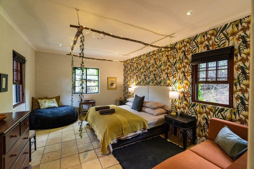 Botanica Cabin showing interior of the bedroom with yellow blanket on bed