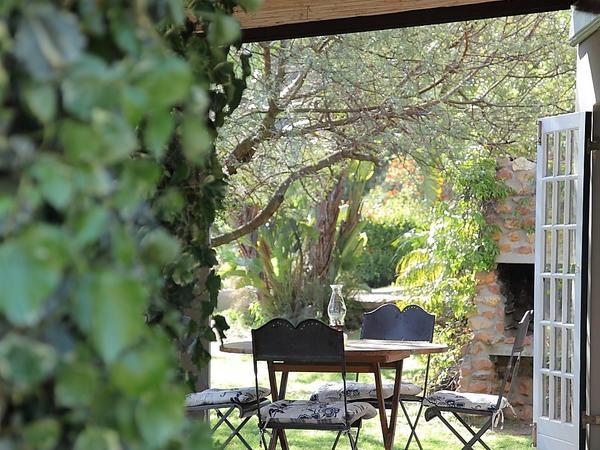 The Farmhouse at Porcupine Hills: Steamy stone wood-fired hot tub against misty dramatic crag