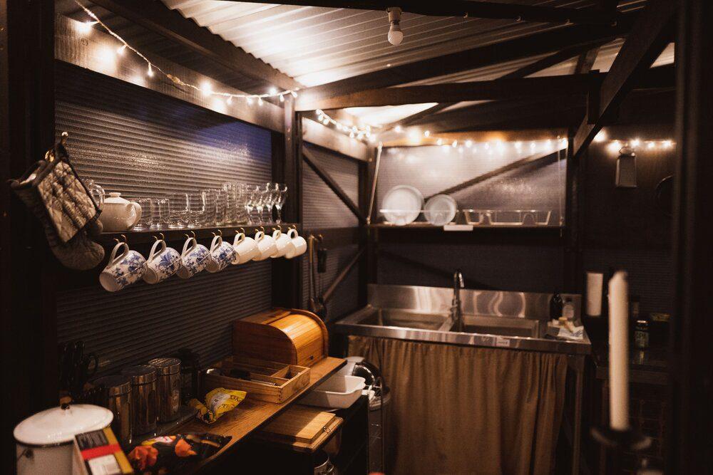 Malachite Yurt interior of the kitchen at night showing mugs and kitchen features