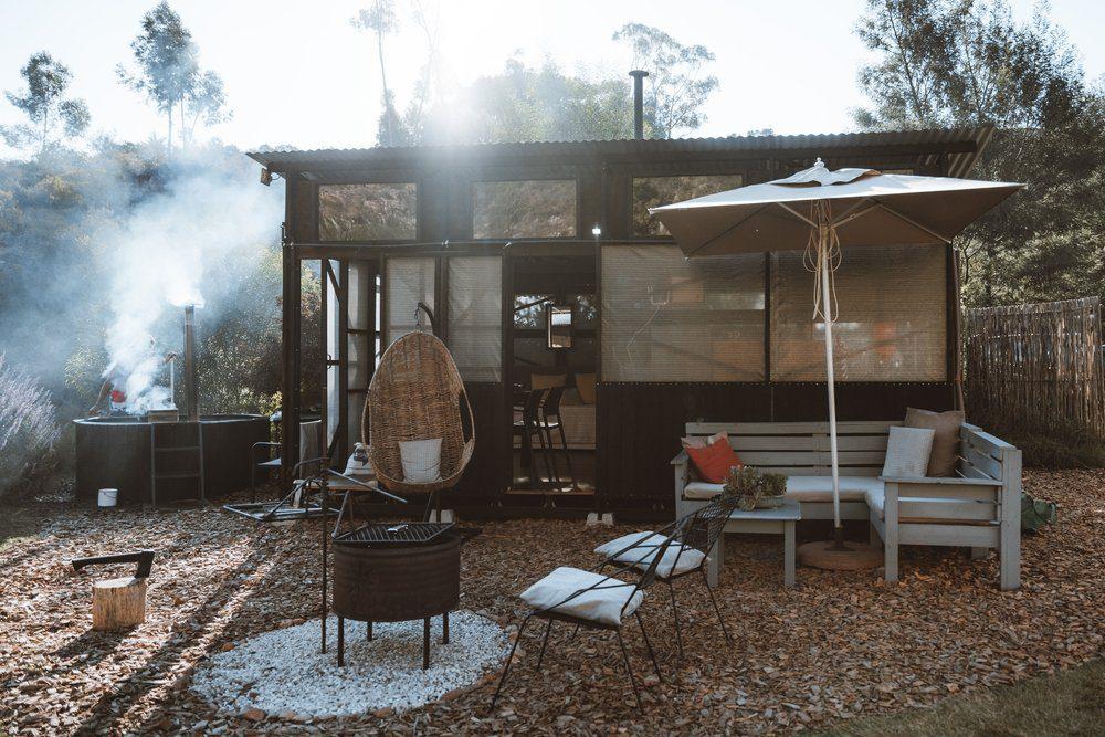 Malachite Yurt exterior showing a braai area, umbrella and seating area