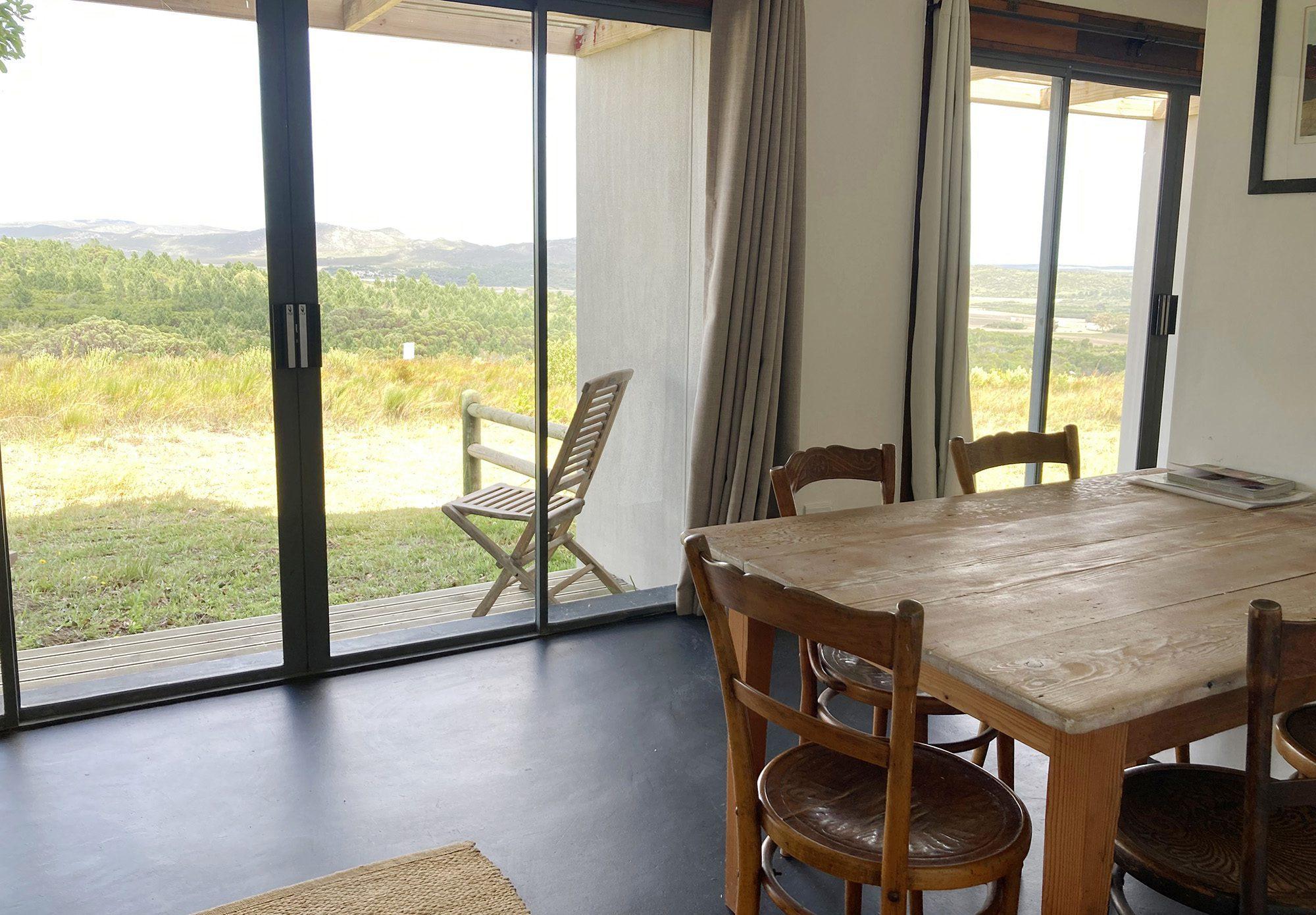 House on 215 view of the dining table with views of nature in the background