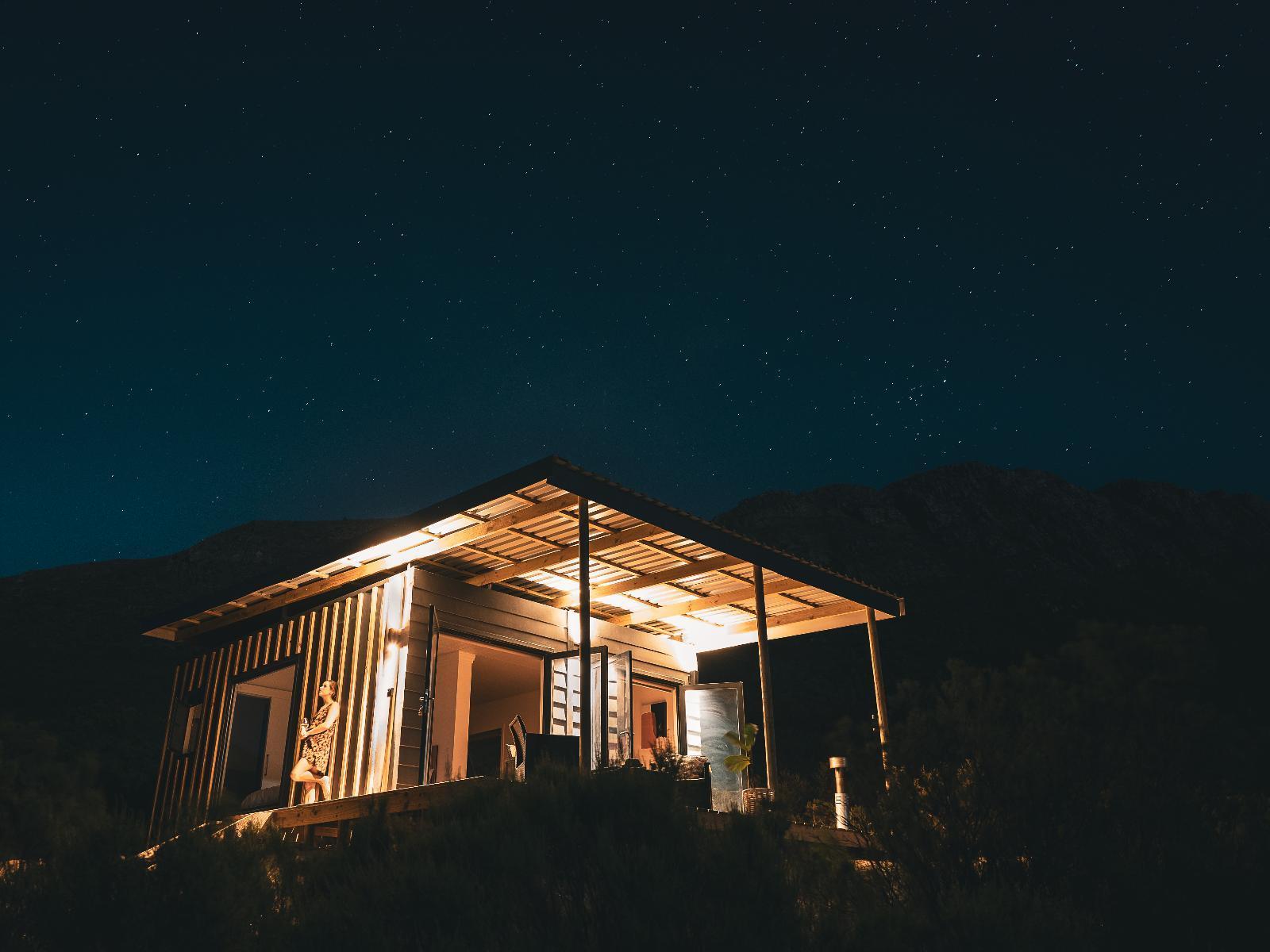 Radio Nowhere Cabin: Glowing cabin lit up under a starry night sky